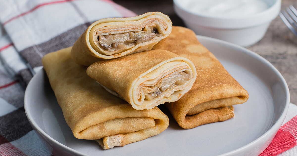 Découvrez la recette de crêpes roulées aux champignons et béchamel au comté